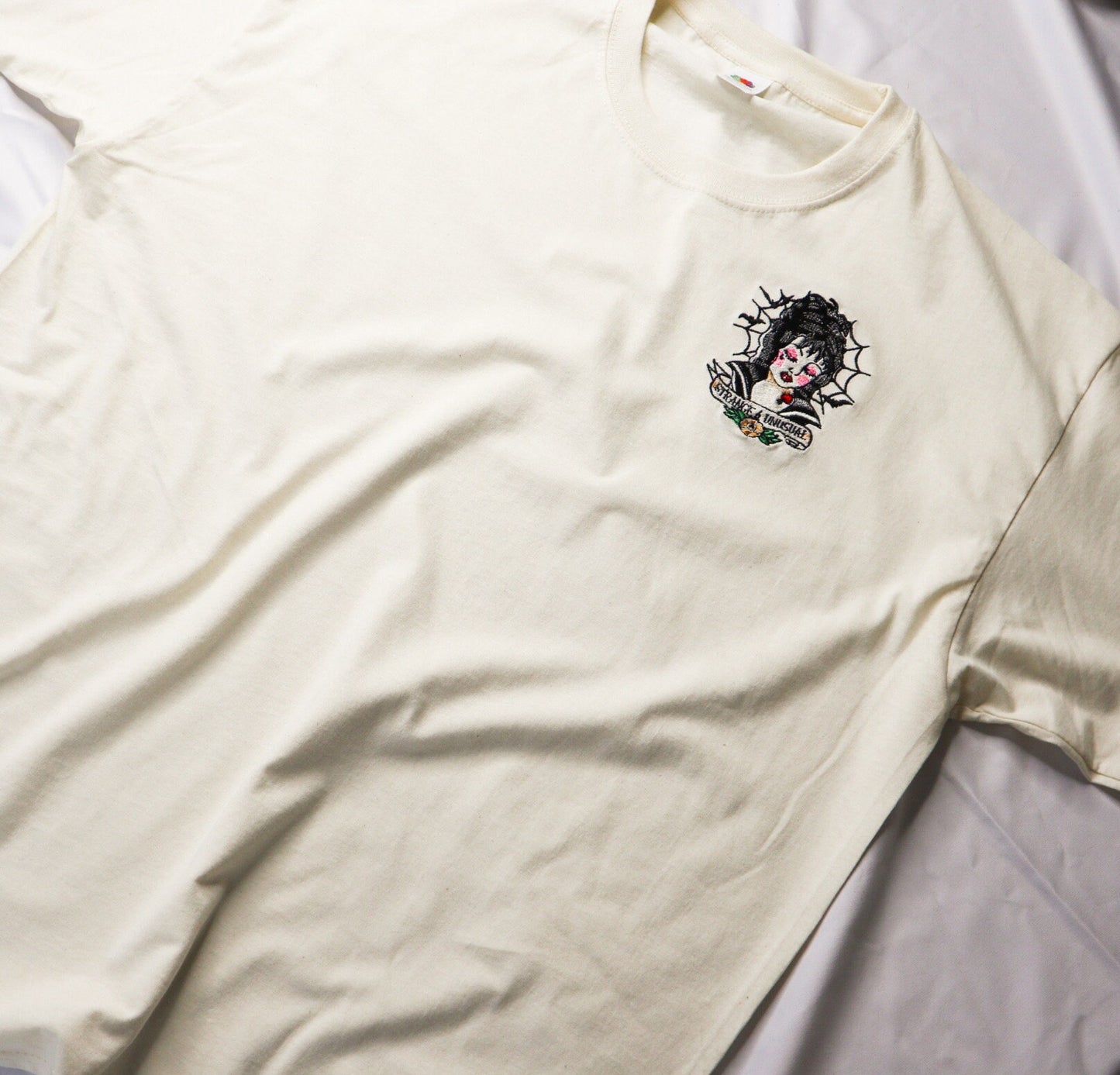 Strange And Unusual Embroidered T-Shirt